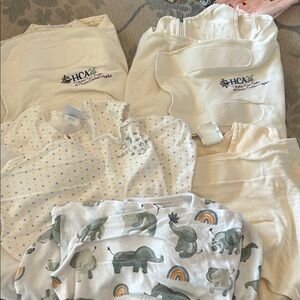 5 sleep sacks, NB and 3-6month sizes, and 8 swaddle blankets.